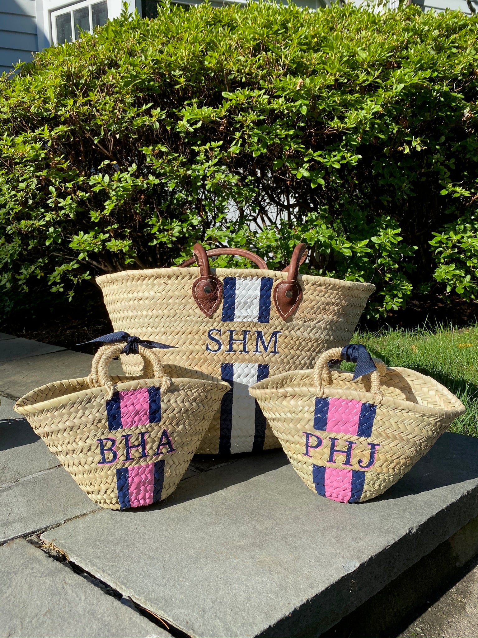 Mommy and Me custom straw totes displayed with alternative pink and navy hand-painted initial monograms.