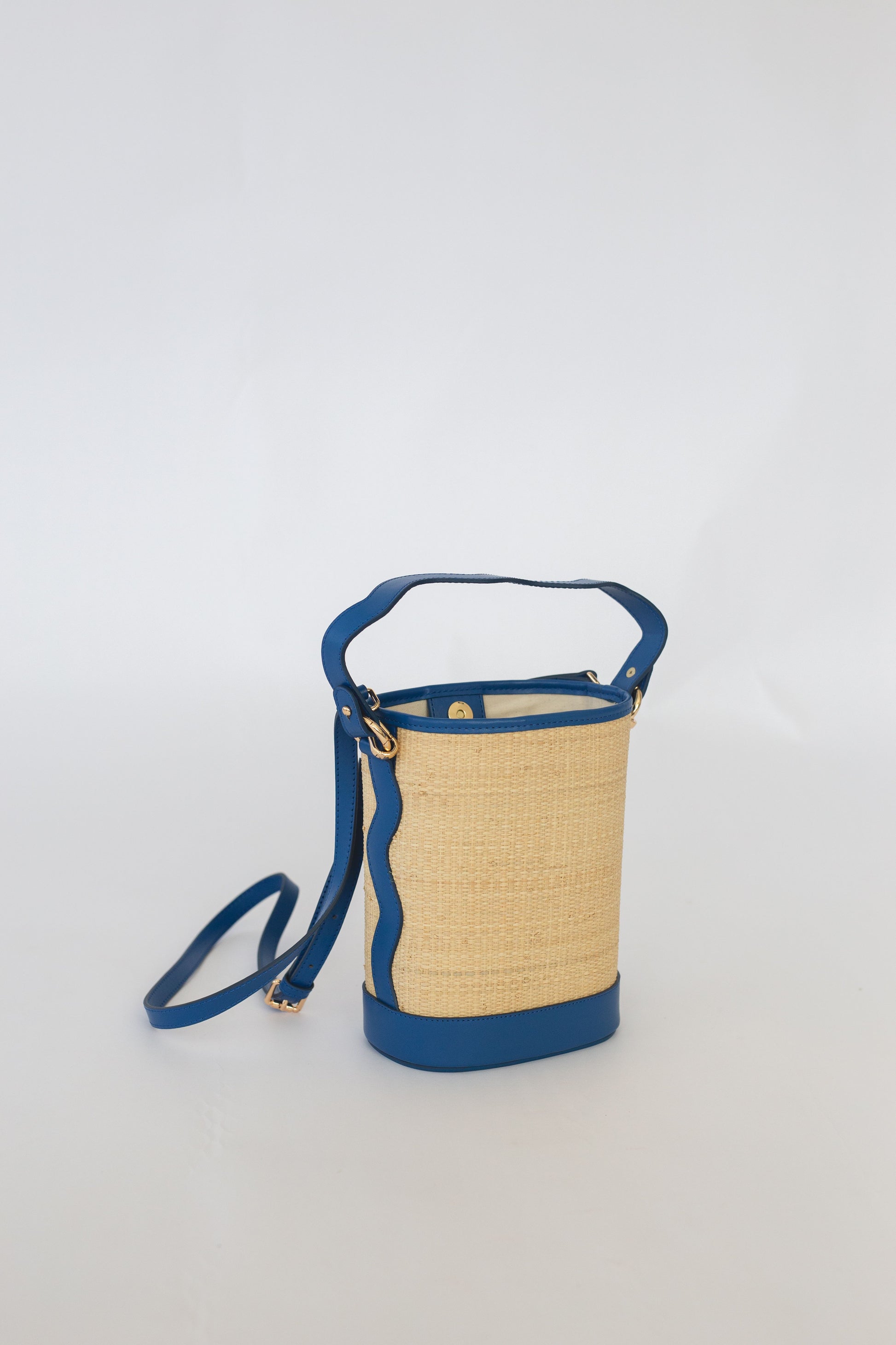 Woven handbag with blue accents on a white background