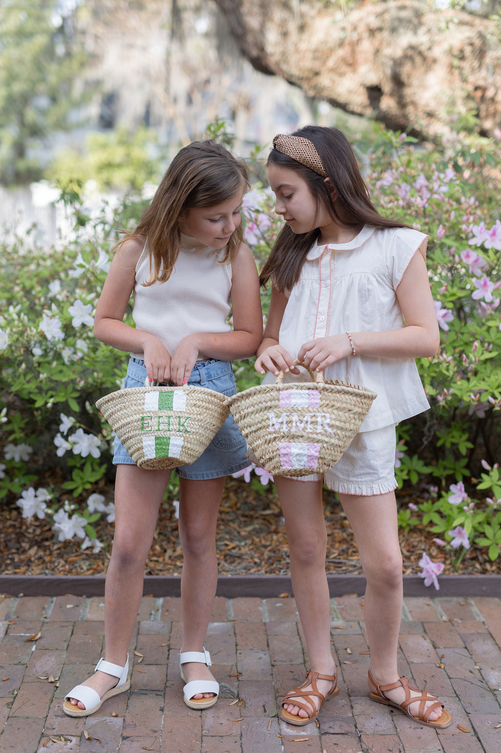 A collection of personalized Quinn mini hand-woven basket bags displaying a variety of custom monogram styles and paint colorways.