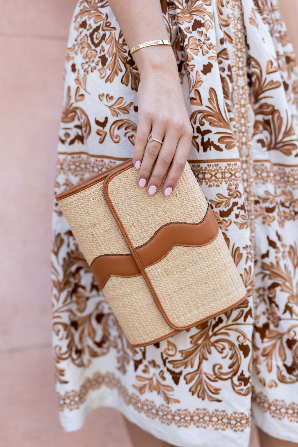Close-up shot highlighting the premium, tight artisan weave pattern of the natural rattan Allie clutch.