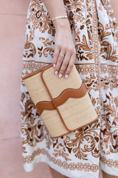 Close-up shot highlighting the premium, tight artisan weave pattern of the natural rattan Allie clutch.