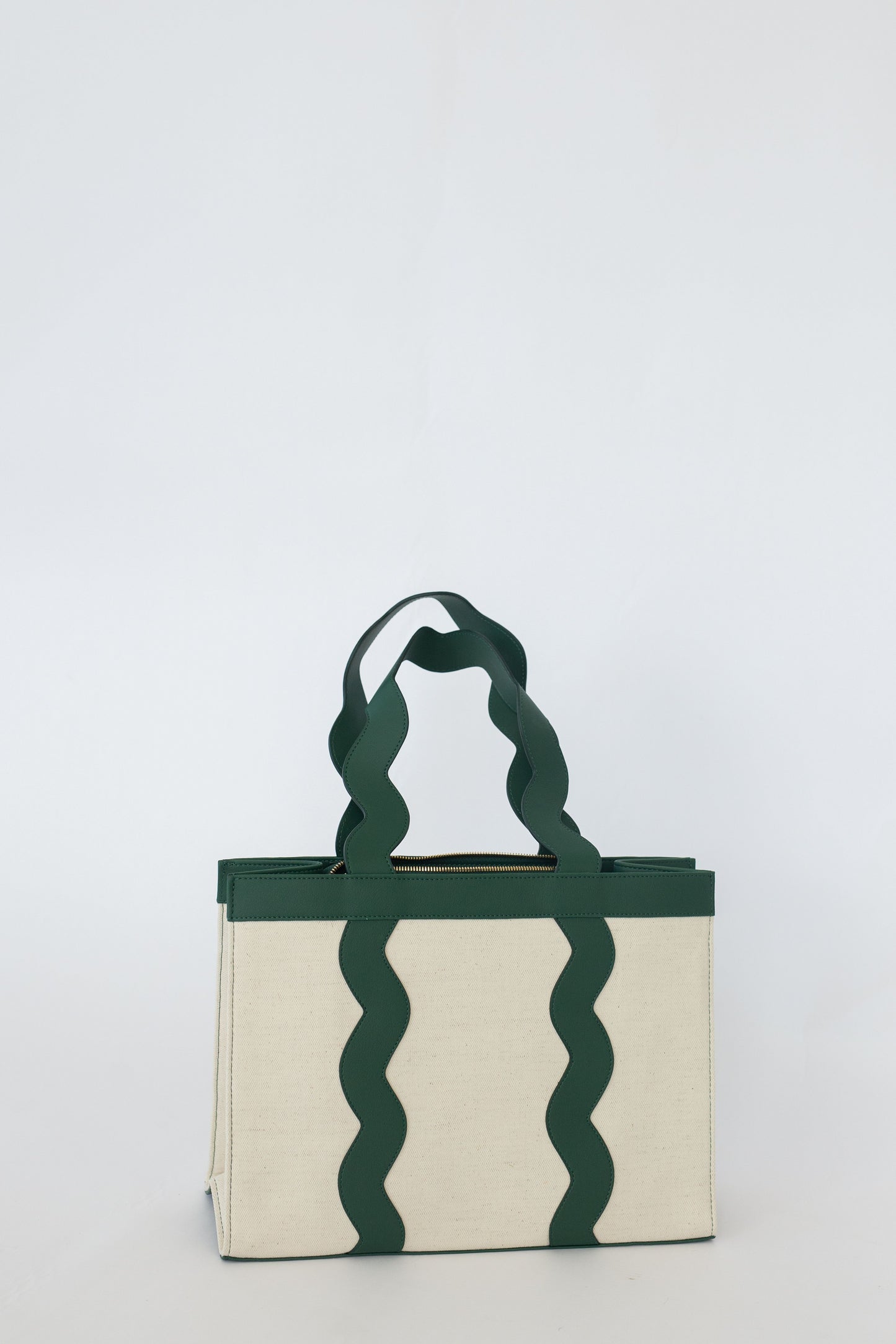 Tote bag with wavy green handles on a white background