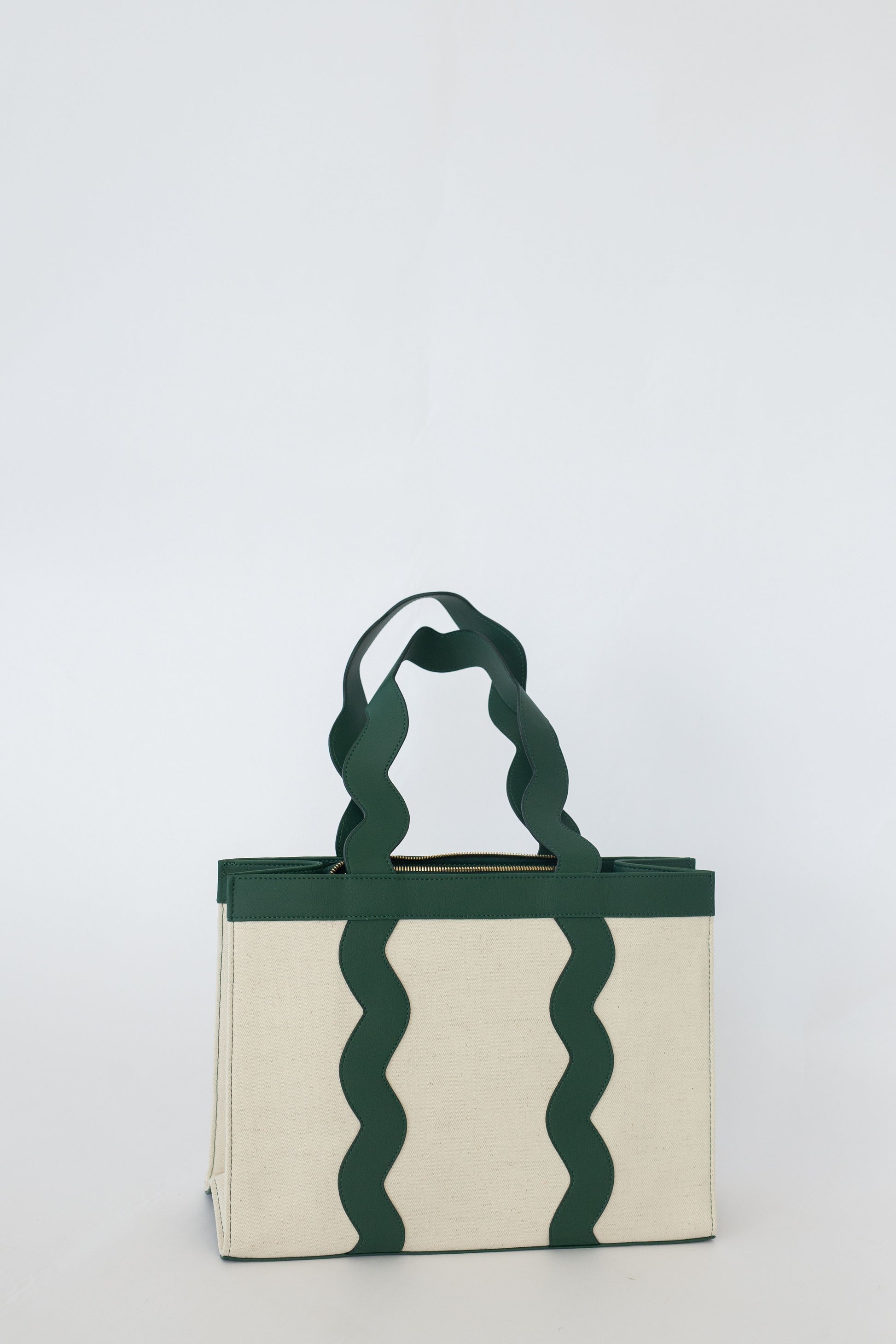 Tote bag with wavy green handles on a white background