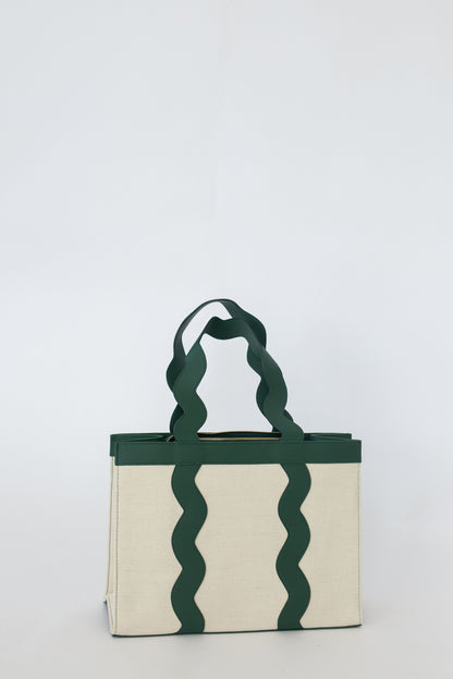 Tote bag with wavy green handles on a white background