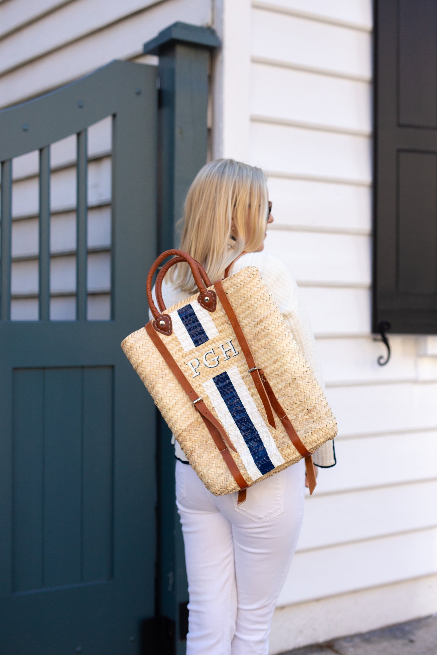 Breck & Grier Phebe custom hand-painted woven straw backpack with personalized shadow initials and vertical navy and white stripes.
