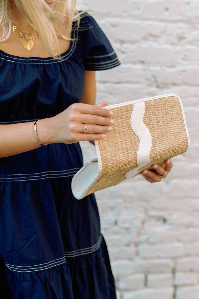Exterior view of the open Allie rattan handbag.