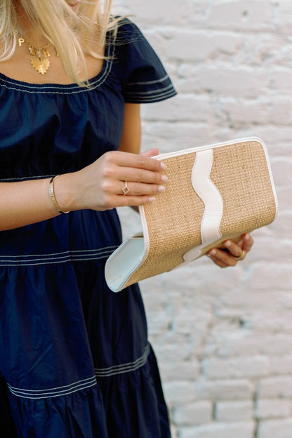 Exterior view of the open Allie rattan handbag.