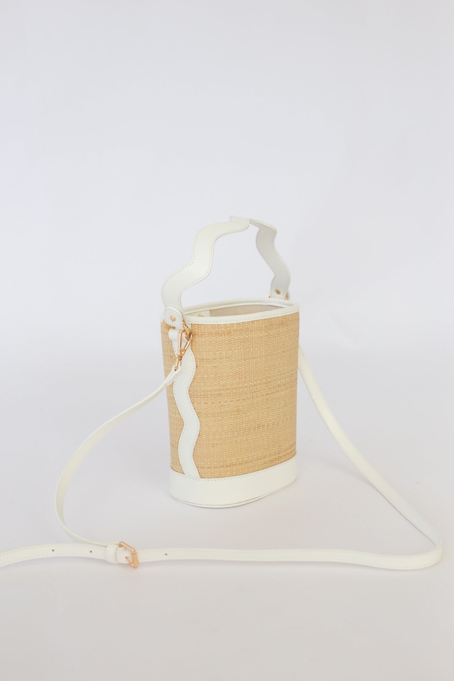 Woven bag with a strap on a white background