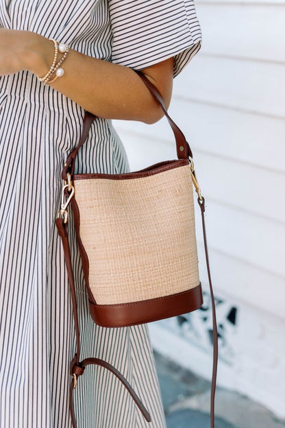 Full front view of the Boo woven rattan market tote showcasing its symmetrical handles and clean silhouette.