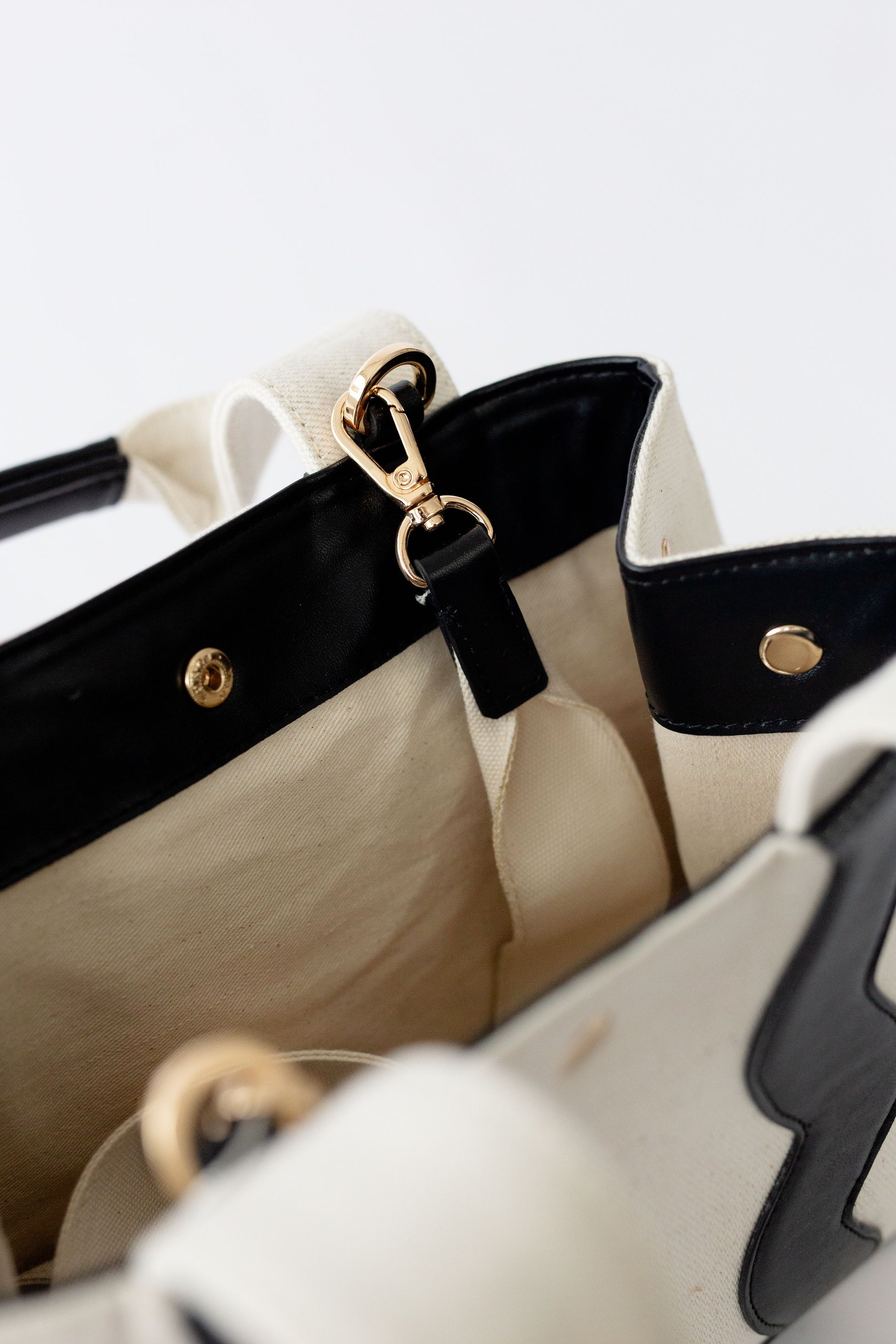 Top view of the Sydney canvas bag open, showcasing the interior space and the secure metal snap closure.