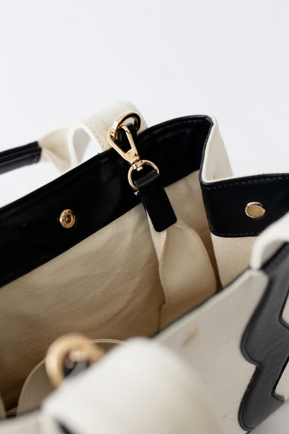 Top view of the Sydney canvas bag open, showcasing the interior space and the secure metal snap closure.