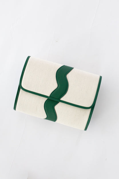 White clutch bag with green leather scallop on a white background