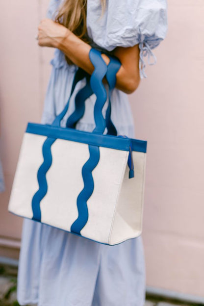 The Grier scalloped canvas tote displayed in a blue leather trim color option.