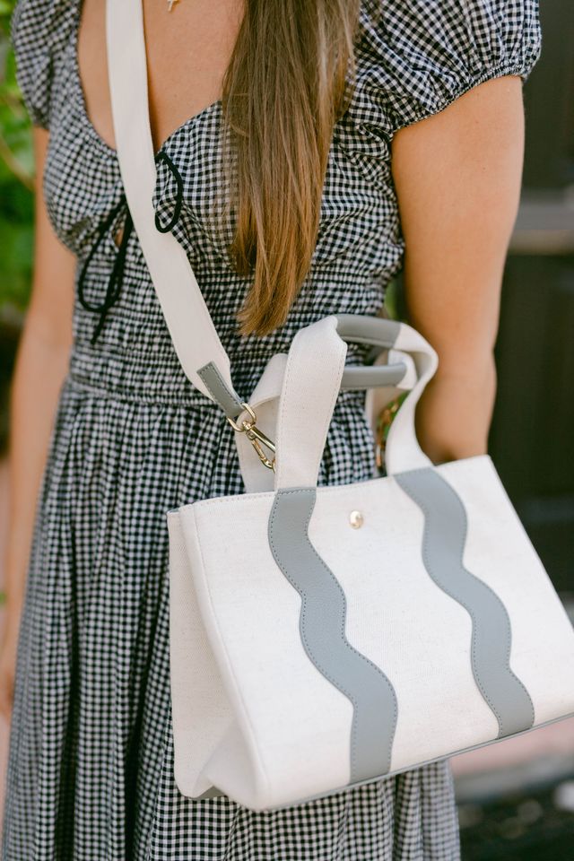 Model wearing the Sydney tote hands-free as a crossbody bag using the long, adjustable shoulder strap.