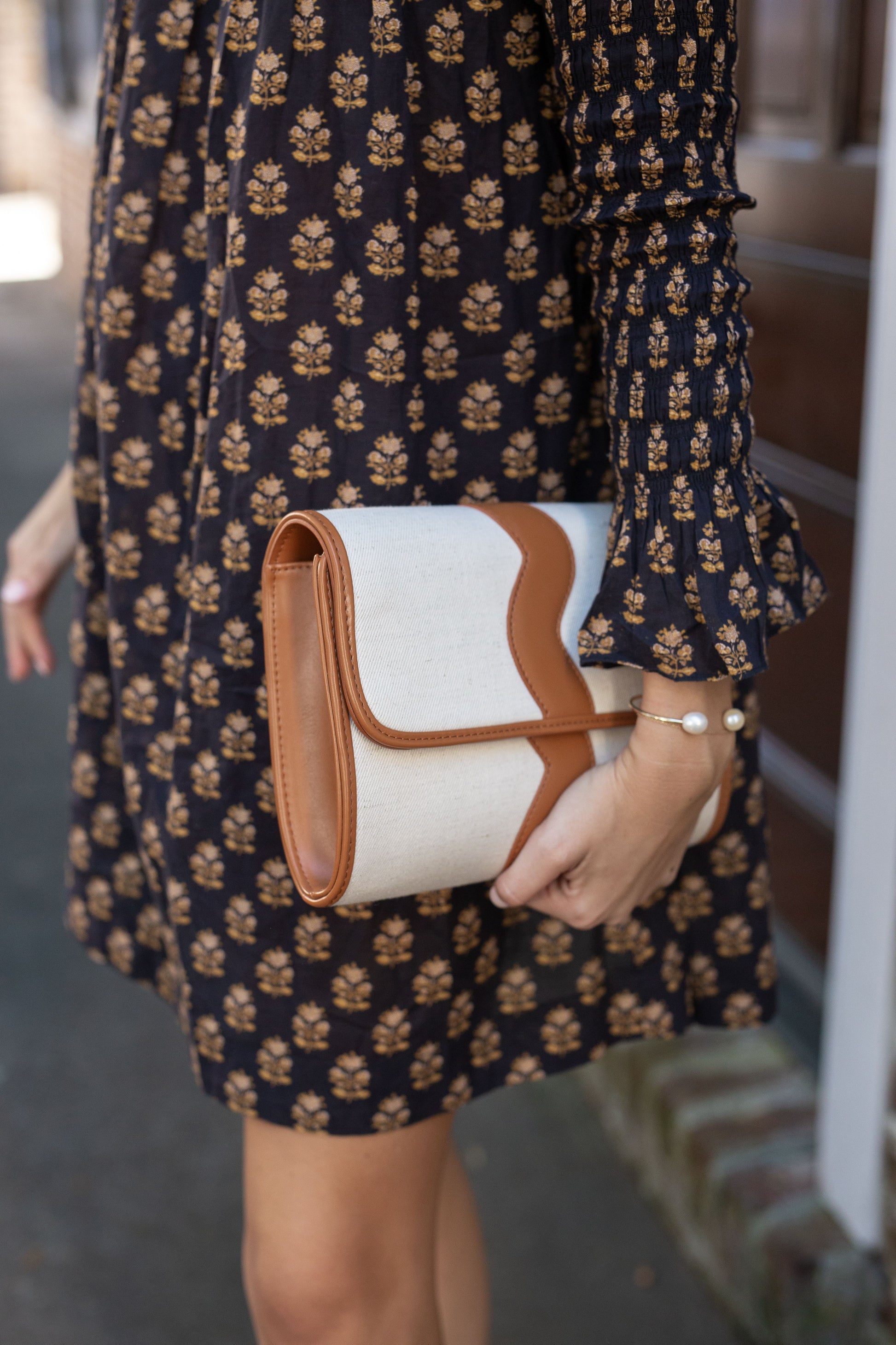 Side angle profile view of the Allie canvas cocktail bag, highlighting its spacious 3-inch depth and structural base.