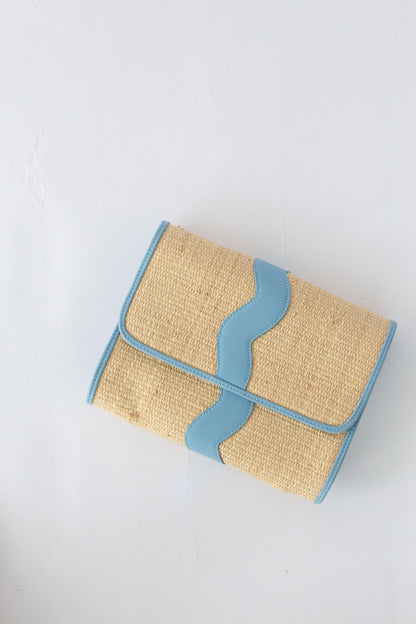 Woven clutch with blue accents on a white background